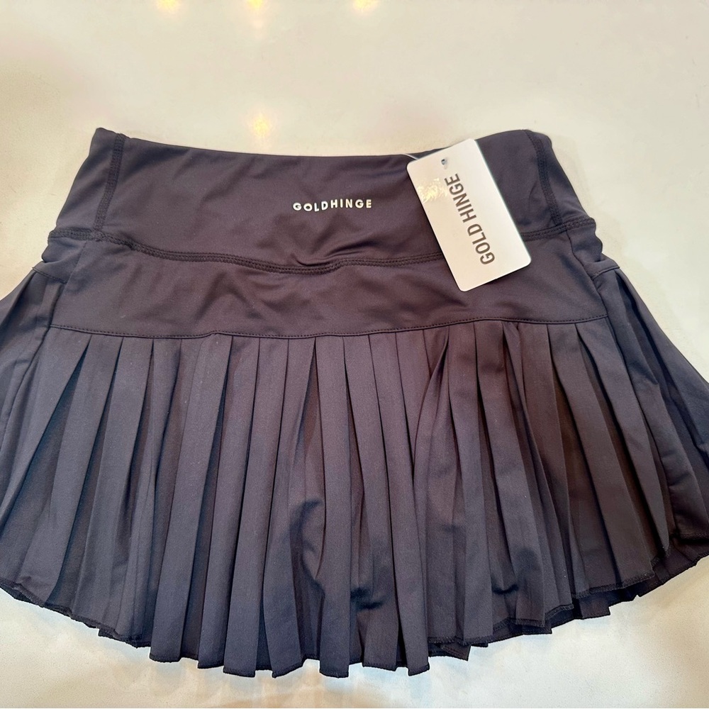 Gold Hinge black pleated tennis skirt.
